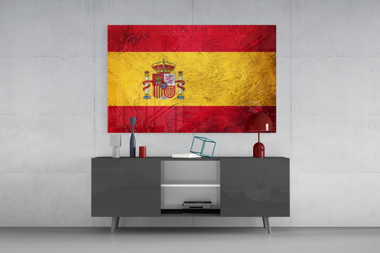 Spanish flag glass wall art with red and yellow horizontal stripes and coat of arms displayed above modern gray media console.