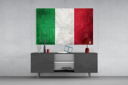 Italian flag glass wall art with textured green, white, and red stripes displayed above a dark media console in a modern interior setting.
