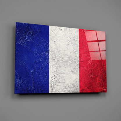 French flag glass wall art in blue, white, and red stripes displayed at an angle against gray background, showing textured surface.