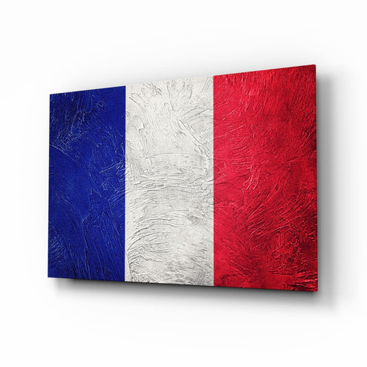 Three-dimensional glass wall art displaying the French flag with blue, white, and red vertical stripes in textured finish, photographed at an angled perspective.