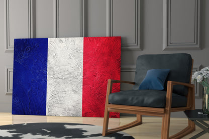French flag glass wall art displayed in modern living room interior with wooden chair and gray paneled wall.