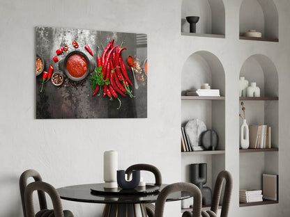 Red Peppers Glass Wall Art displayed above a round black dining table in a modern minimalist interior with white built-in shelving.