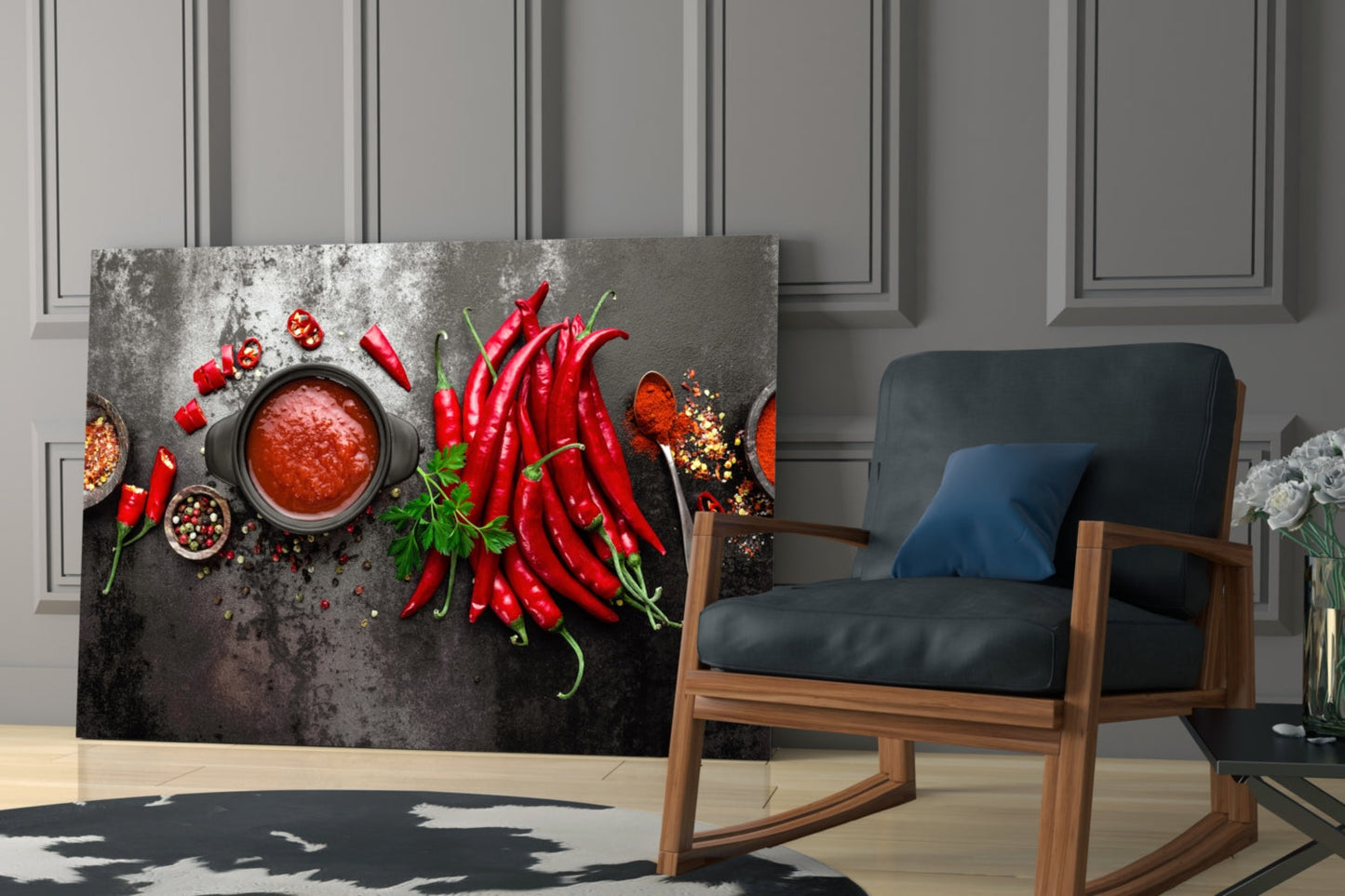 Red peppers glass wall art displayed in a modern living room with wooden chair and grey paneled walls.