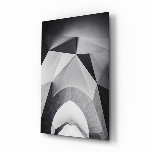 Black and white architectural photograph of geometric vault ceiling with angular planes displayed as mounted glass wall art.
