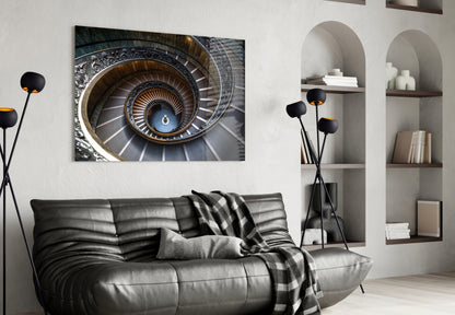 Spiral staircase artwork displayed above black leather sofa in modern living room with white built-in shelving.