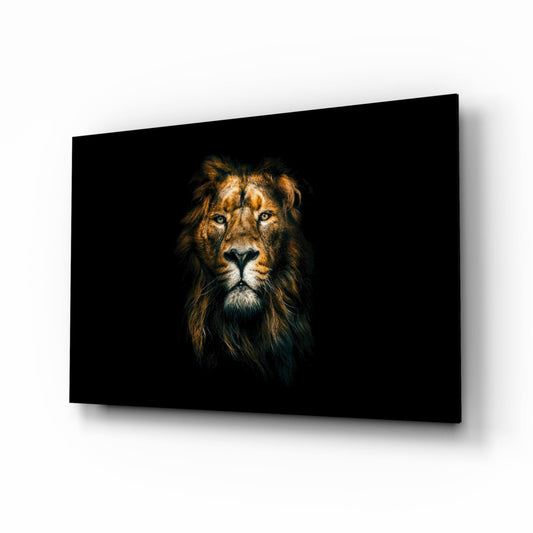 Angled view of black glass wall art displaying a majestic lion's head with golden mane against dark background.