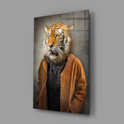 Tiger head glass wall art displayed at an angle, showing a tiger wearing a brown jacket and dark shirt against a textured gray background.