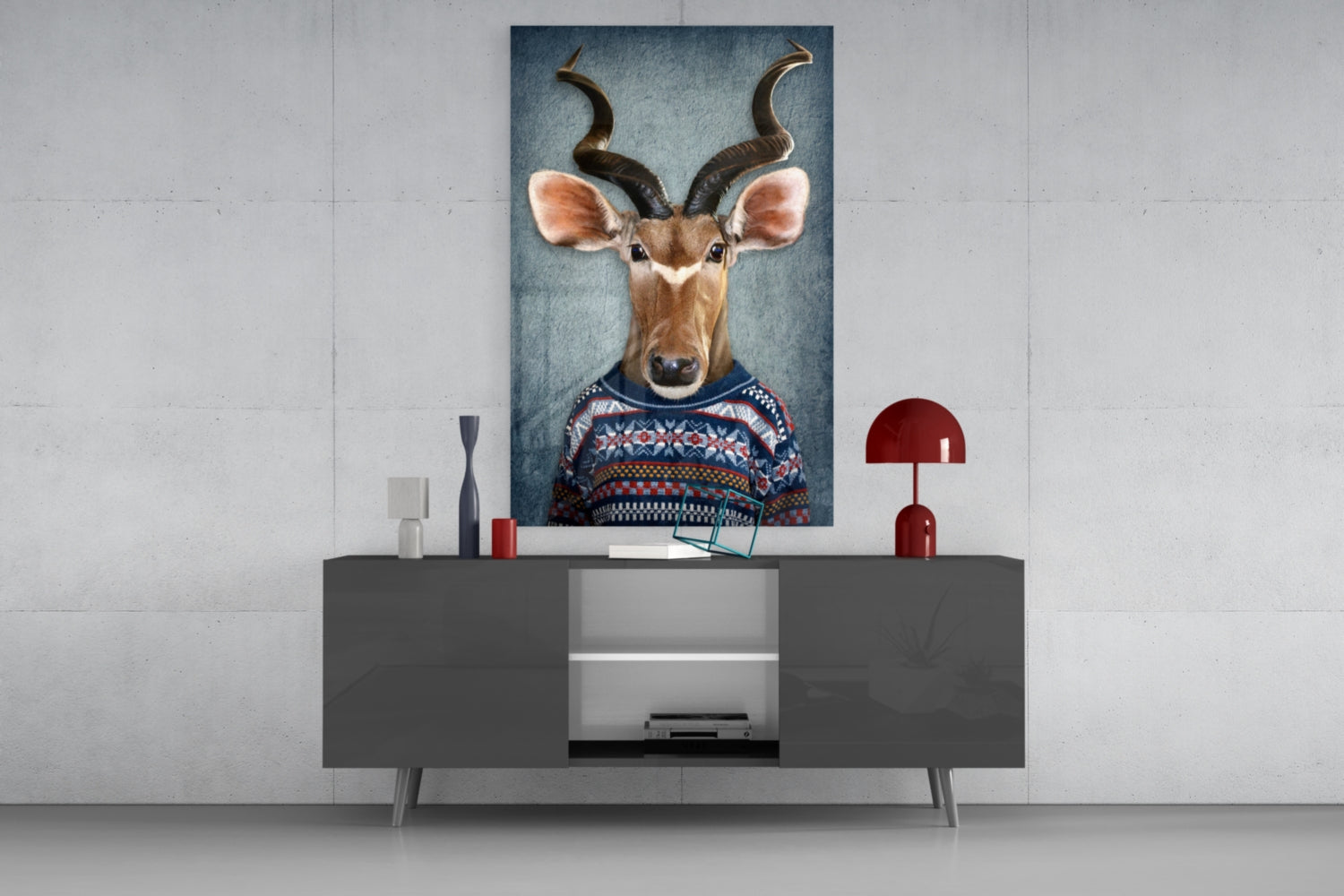 Deer head glass wall art displayed above a dark gray media console, showing an antelope wearing a patterned sweater against a blue background.