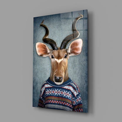 Antelope wearing patterned sweater displayed on angled blue-gray glass panel against white wall.