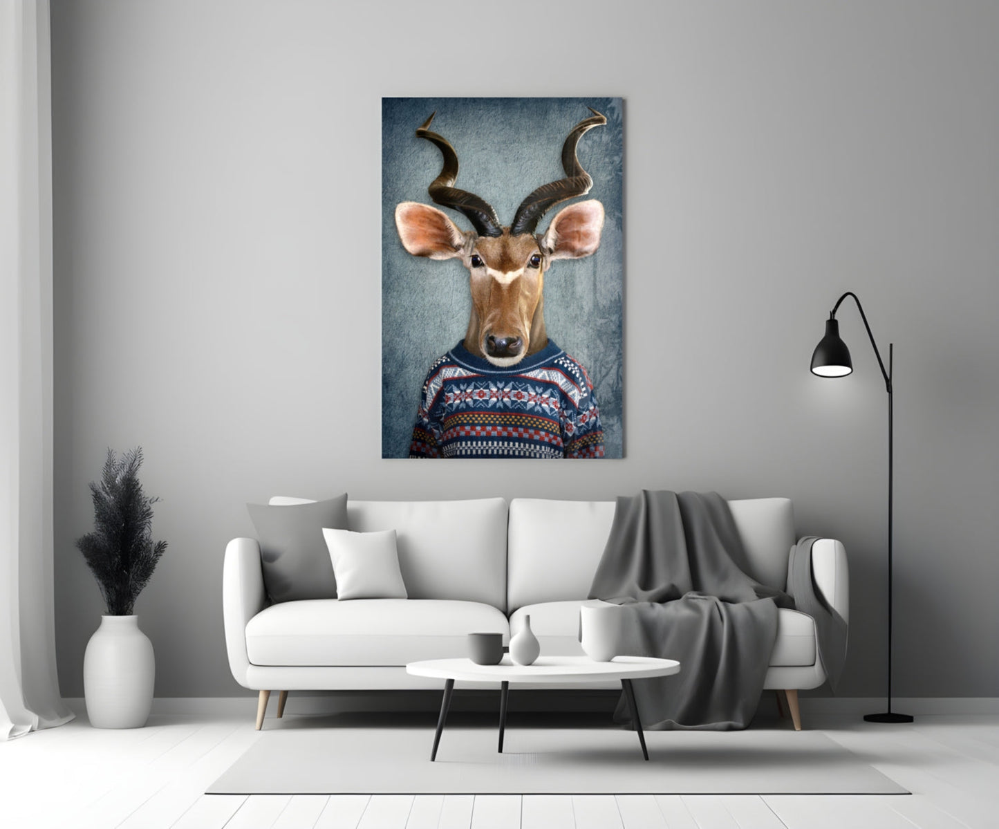 Deer Head Glass Wall Art displayed above white sofa in modern living room setting, showing antelope wearing patterned sweater against blue background.