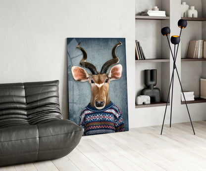 Modern living room featuring deer head glass wall art leaning against wall, displaying antelope wearing patterned sweater on blue background.