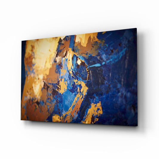 Angled product display of blue and gold textured glass wall art with thick impasto brushstroke effects and deep shadow relief.