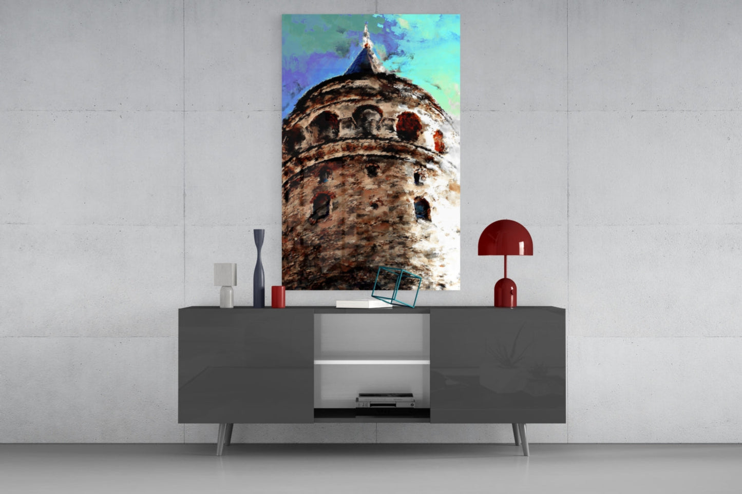 Galata Tower glass wall art displayed above gray media console, showing weathered stone tower with turquoise sky and decorative accessories.