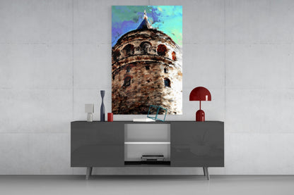 Galata Tower glass wall art displayed above gray media console, showing weathered stone tower with turquoise sky and decorative accessories.
