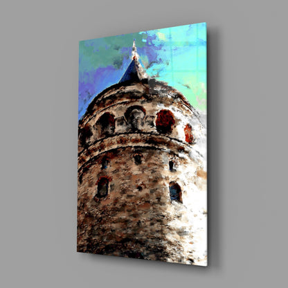 Angled view of glass wall art depicting historic tower with stone texture, arched windows, and colorful blue-green sky gradient background.