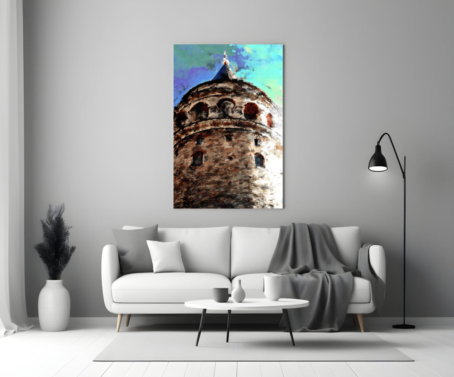 Galata Tower glass wall art with textured stone tower and vibrant blue-green sky, displayed above white sofa in modern living room.