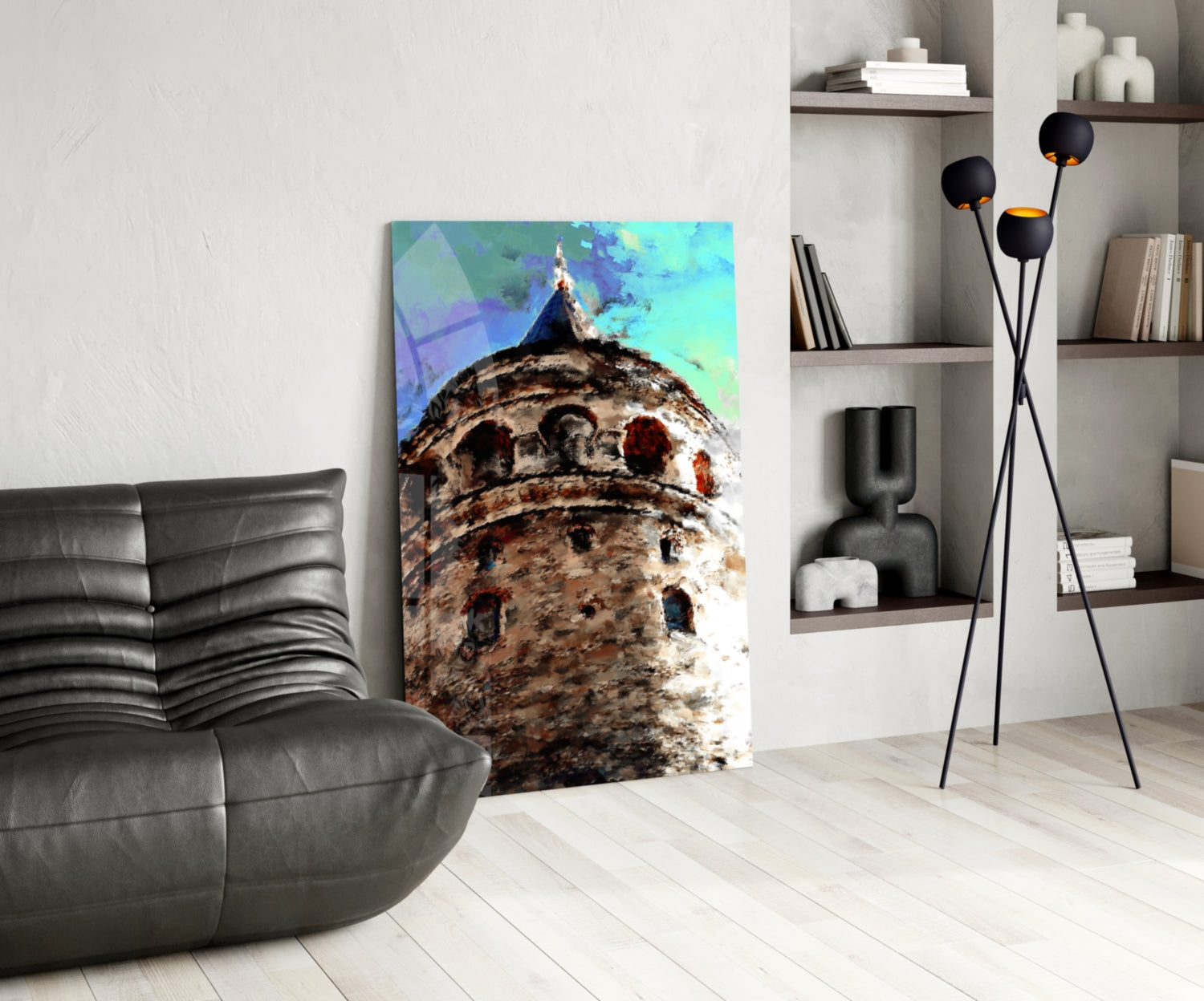 Vertical glass wall art depicting a textured stone tower with turquoise sky displayed in modern living room setting.