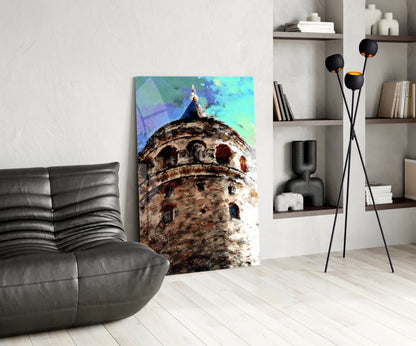 Vertical glass wall art depicting a textured stone tower with turquoise sky displayed in modern living room setting.