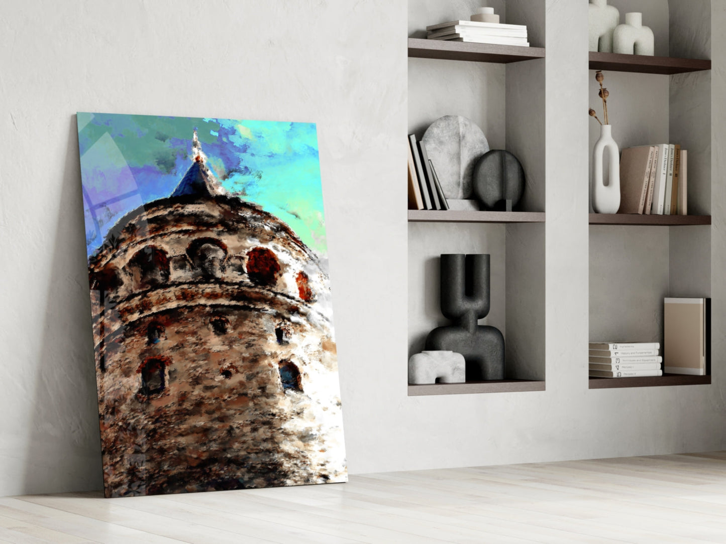 Galata Tower glass art leaning against white wall beside shelving, showing textured stone tower base with turquoise sky overlay.