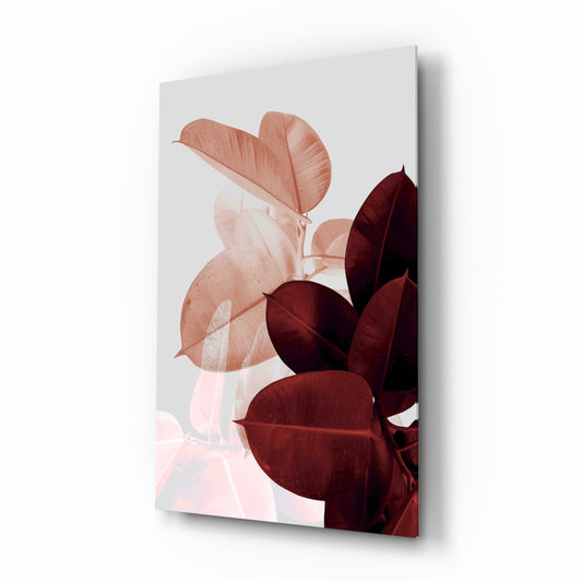 Glass wall art displaying overlapping blush pink and deep burgundy rubber leaves on white background, angled perspective view.