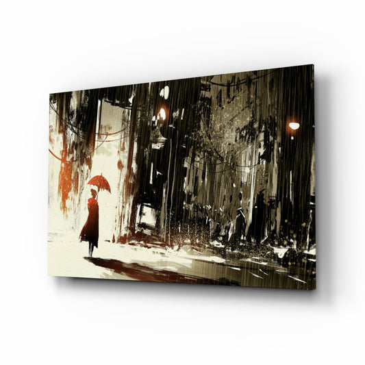 Glass wall art print displaying a figure in red coat holding umbrella on rainy urban street, mounted at angle against white background.
