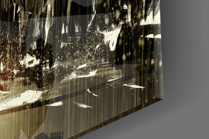 Angled close-up of glass wall art showing sepia-toned snowy mountain landscape with forest and winding road printed on translucent surface.