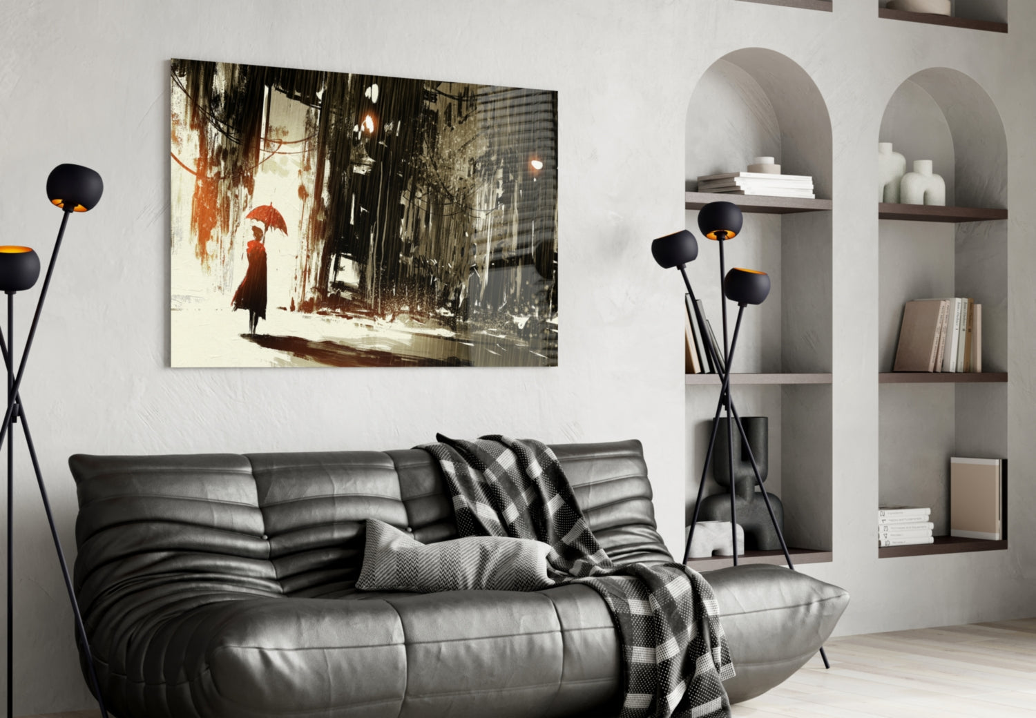 Modern living room with black leather sofa displaying framed glass wall art depicting a woman with red umbrella in rainy urban street scene.