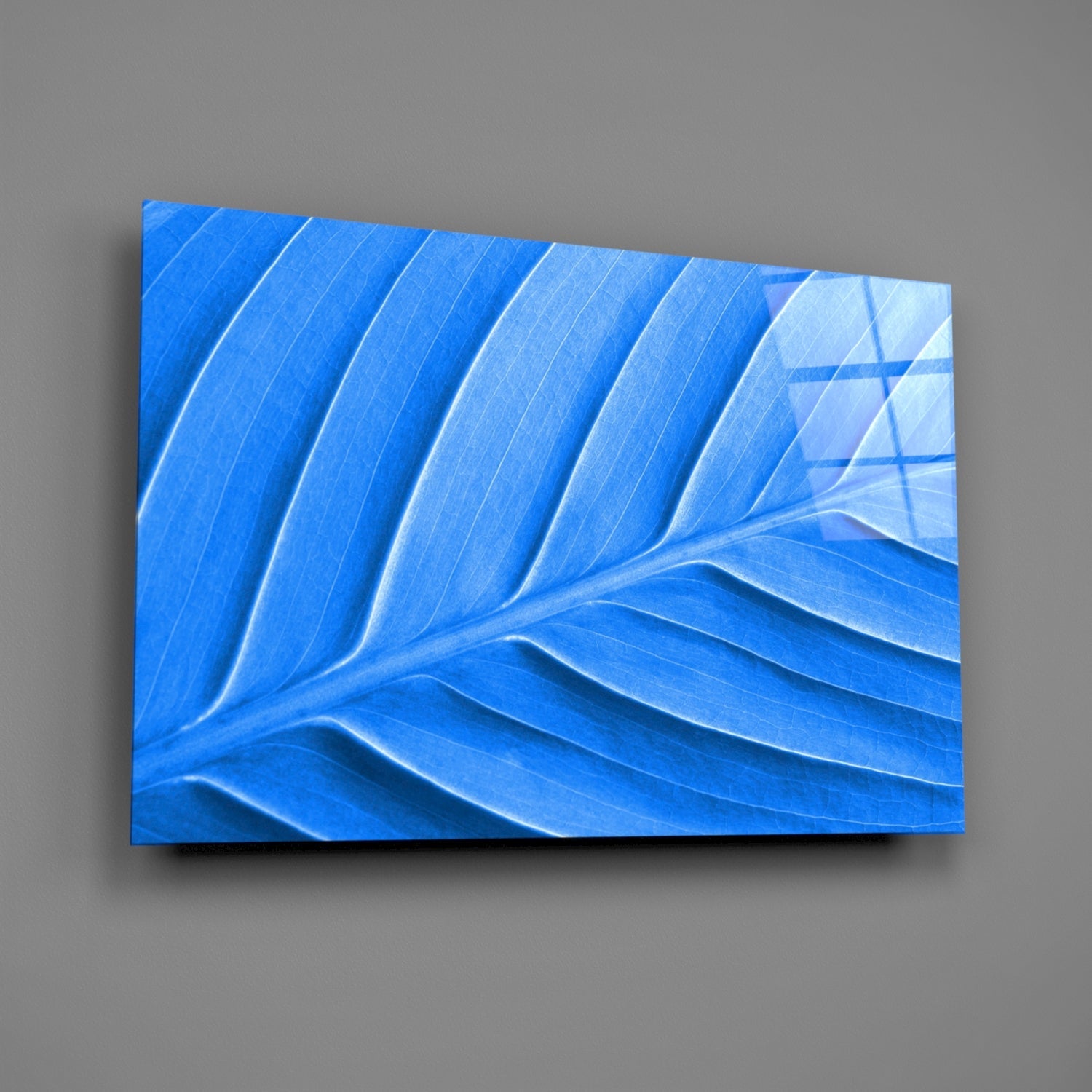 Blue Leaf Glass Wall Art mounted on gray wall, displaying carved leaf veins and gradient blue tones from deep to light.