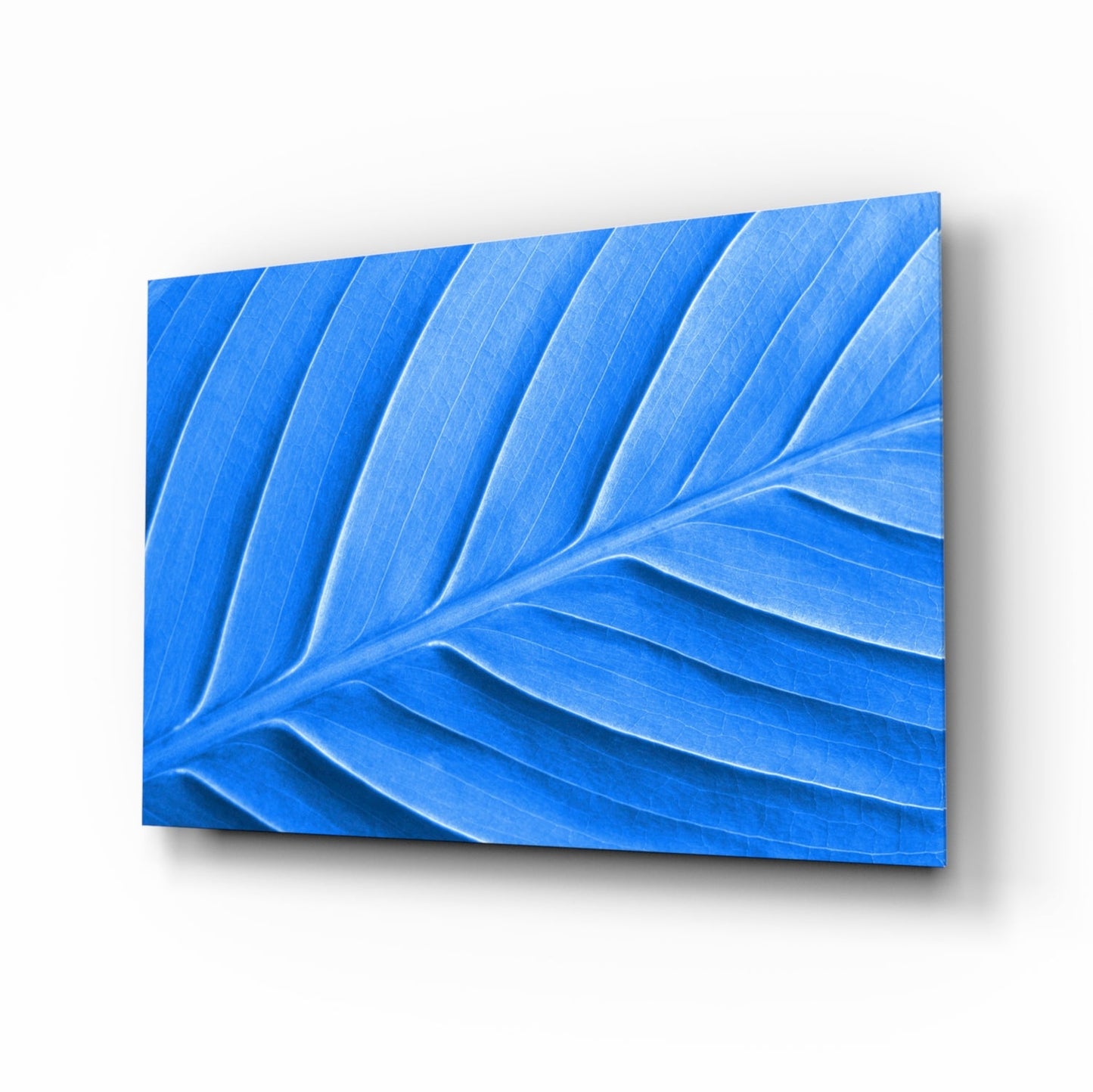 Blue Leaf Glass Wall Art displayed at an angled perspective showing carved leaf vein details and gradient shading.