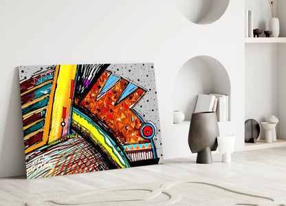 Colorful abstract chameleon glass art leaning against white wall in minimalist interior with decorative objects.