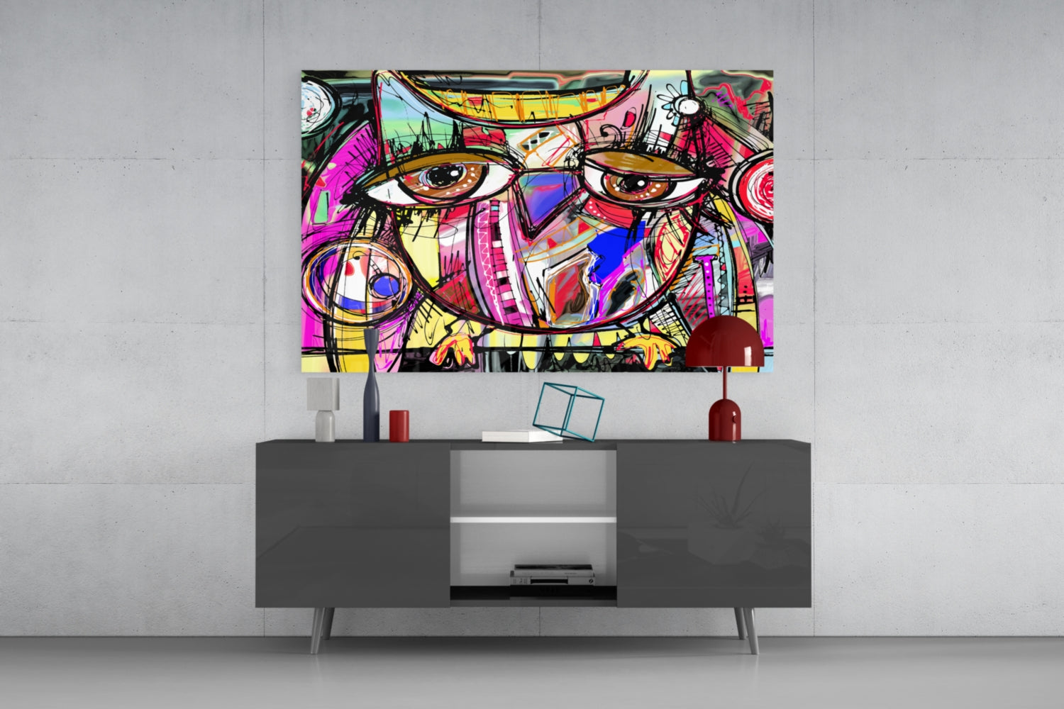 Colorful abstract owl glass wall art hanging above gray TV console, displaying vibrant pink, yellow, and blue geometric patterns with bold black outlines.