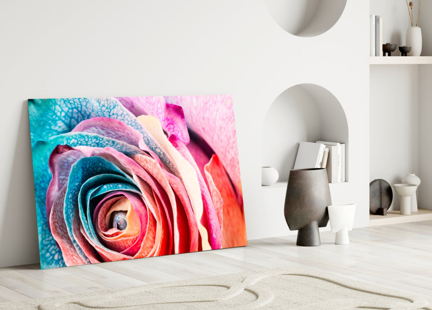 Vibrant multicolored rose glass art leaning against white wall in minimalist interior setting with decorative objects.