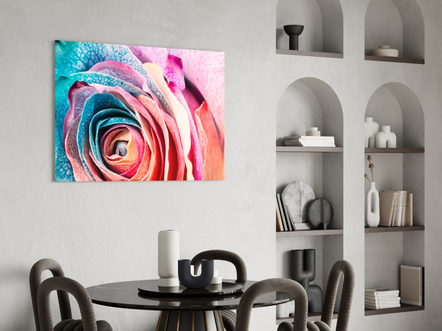 Vibrant multicolored rose glass wall art in pink, turquoise, and orange displayed above a round black dining table in a modern interior.