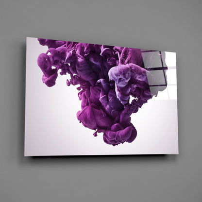 Mounted glass wall art displaying swirling purple and violet ink clouds against white background, viewed at angle on gray wall.