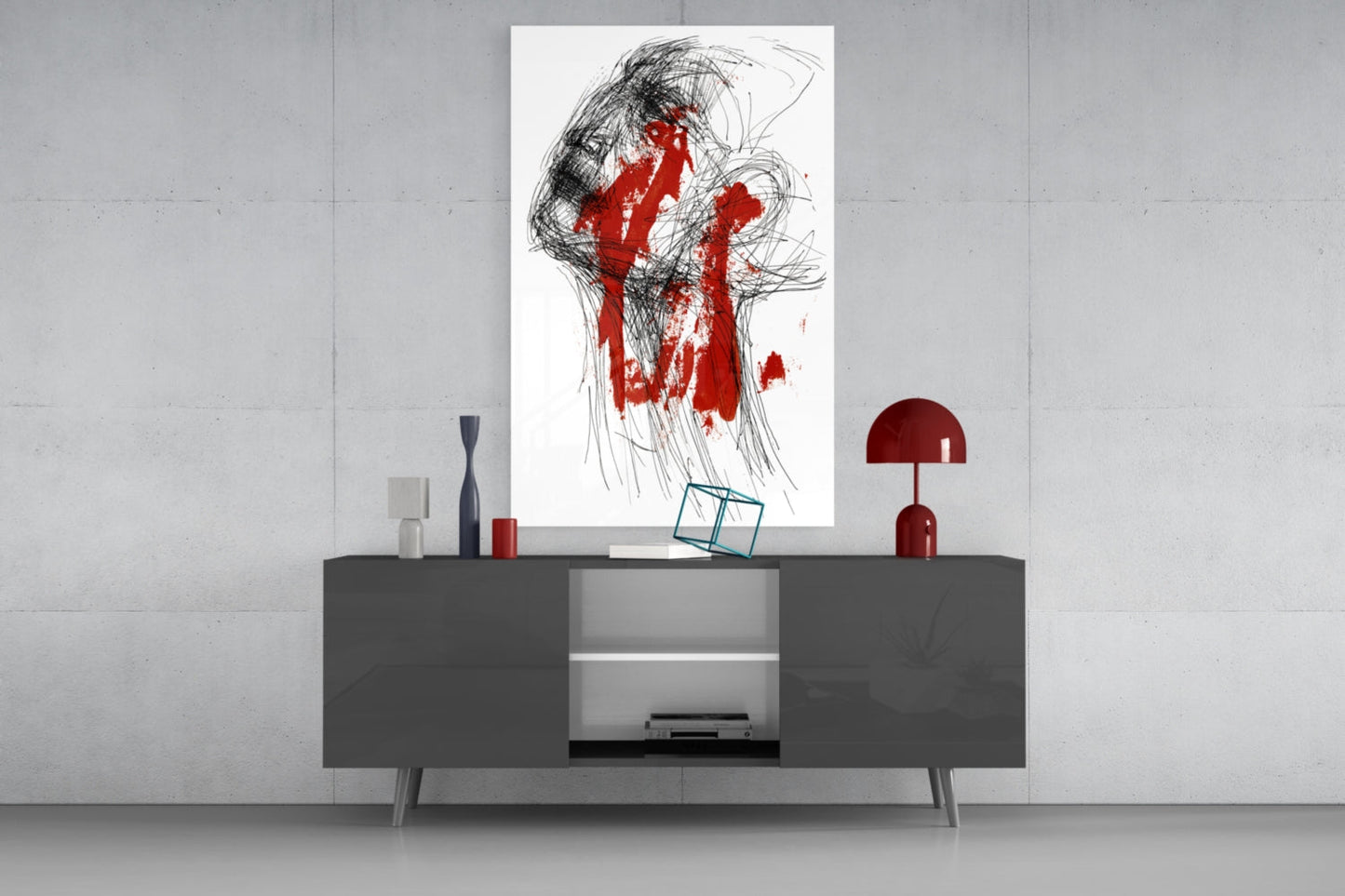 Contemporary living room display featuring abstract portrait glass art with black line drawings and red paint streaks mounted above gray console table with red decorative accessories.
