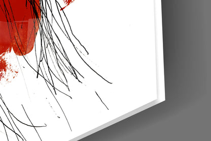 Close-up angled view of red and black brushstroke design on frosted glass panel with white background.