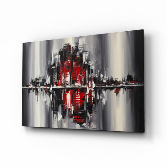 Abstract cityscape glass wall art featuring red and black buildings with gray streaks and mirrored water reflection effect, displayed at angle.