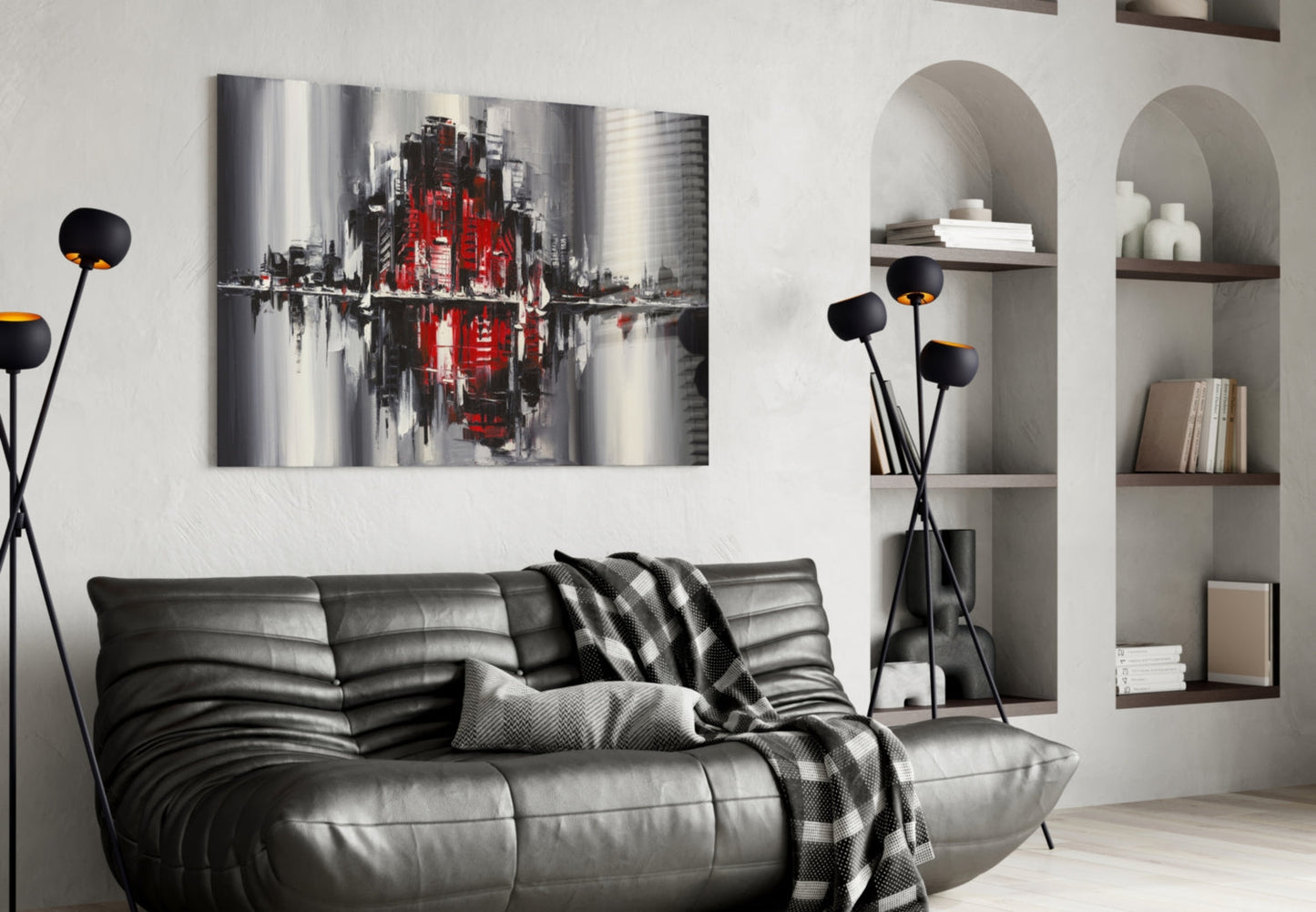 Modern living room with gray leather sofa displaying red and gray cityscape canvas art above it, flanked by white arched shelving.