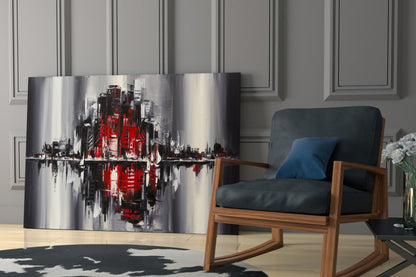 Modern living room with curved glass wall art featuring red and gray abstract cityscape, displayed beside wooden-framed chair with dark cushions.