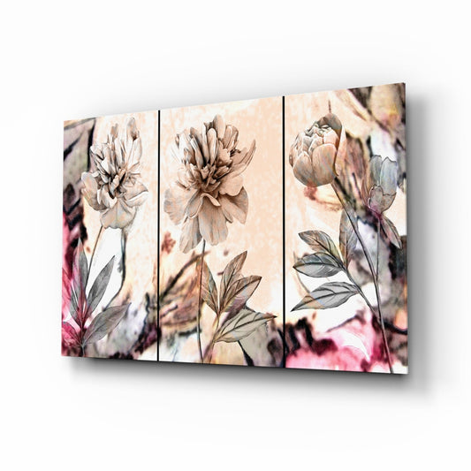 Three-panel glass wall art displaying soft pastel peony flowers in beige and pink tones with green foliage against cream background.