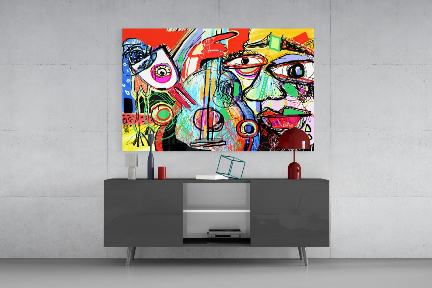 Colorful abstract glass wall art featuring vibrant red, yellow, blue, and green geometric designs with stylized faces displayed above a dark gray media console.