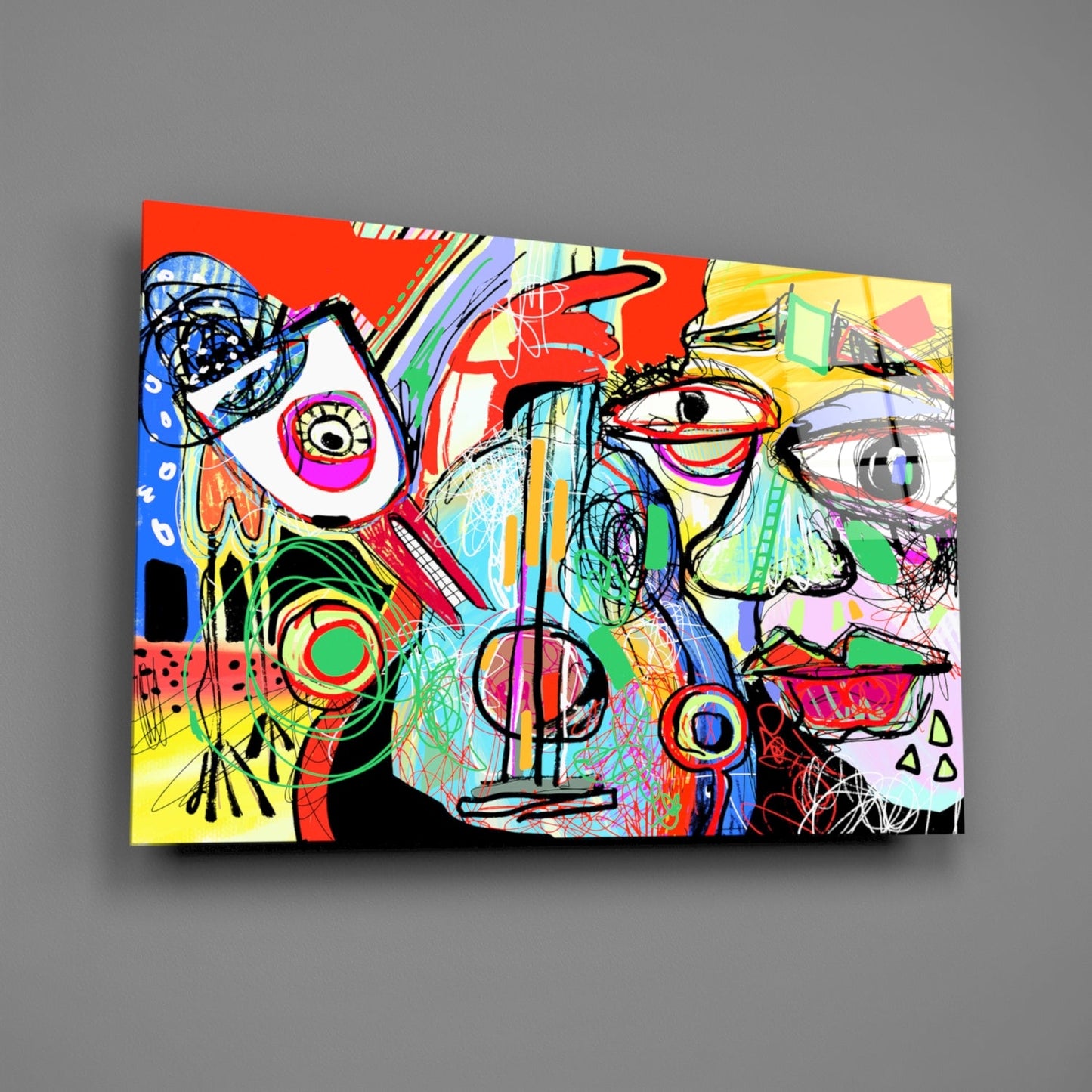 Colorful abstract glass wall art featuring bold geometric faces with vibrant red, yellow, blue, and green sections against a gray background.