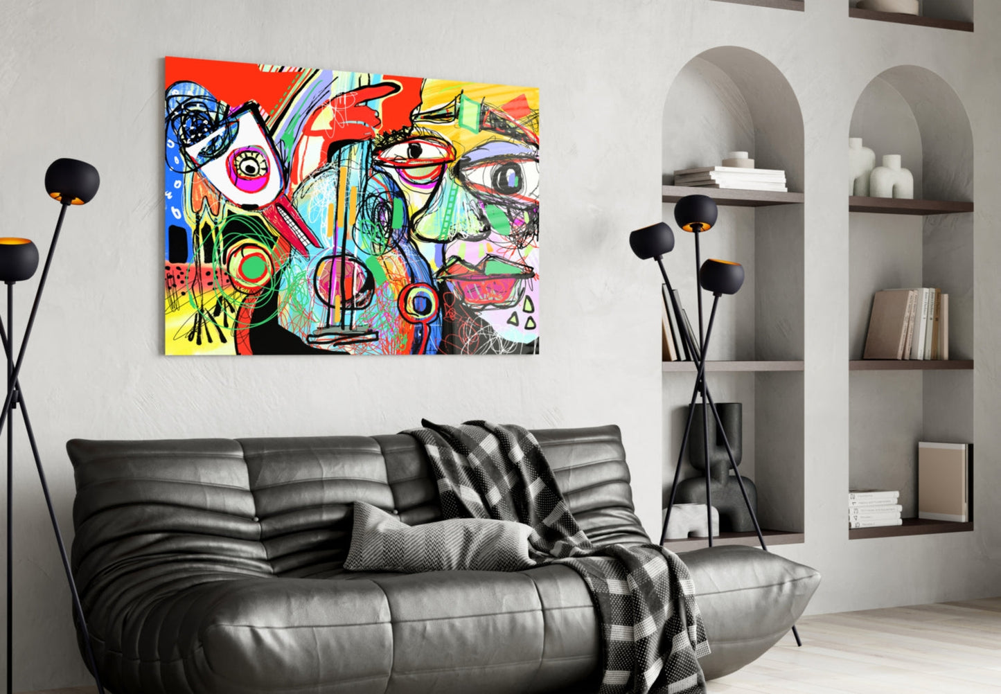 Vibrant abstract glass wall art with colorful geometric patterns and expressive face mounted above black leather sofa in modern living room.