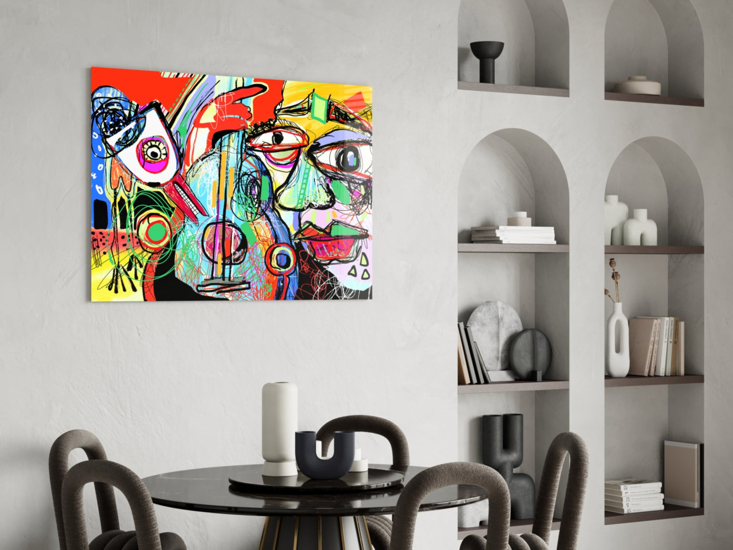 Colorful abstract glass wall art depicting a stylized face with bird and violin elements in vibrant reds, yellows, blues, and greens, displayed above a black dining table in a modern interior.