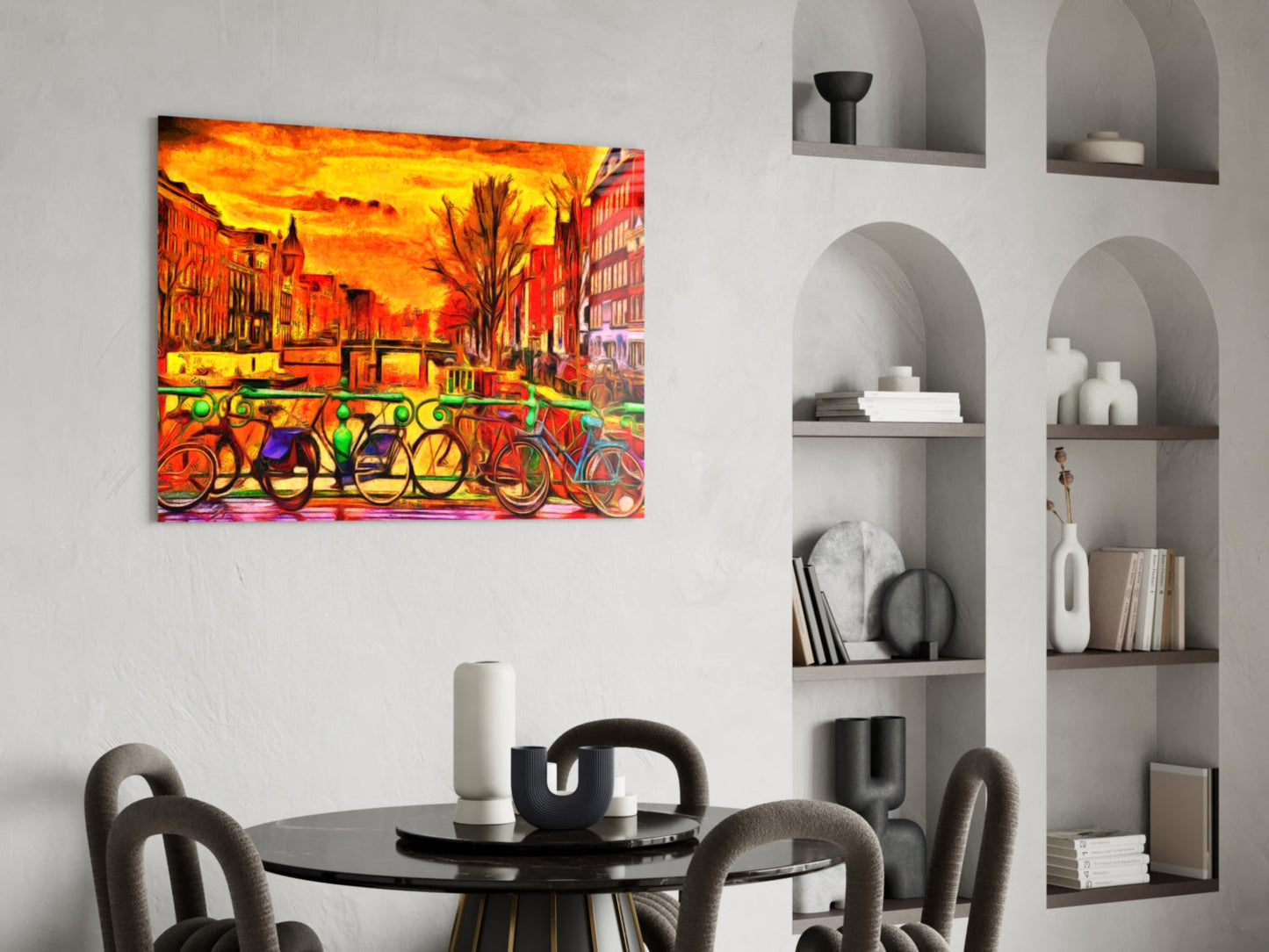 Vibrant glass wall art depicting colorful bicycles against a fiery orange cityscape, displayed above a dining table in a modern interior.