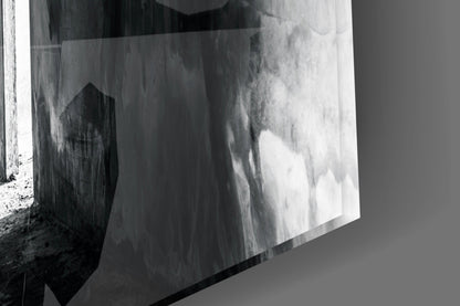 Black and white photograph of a textured concrete wall with dramatic light and shadow effects creating an abstract composition.