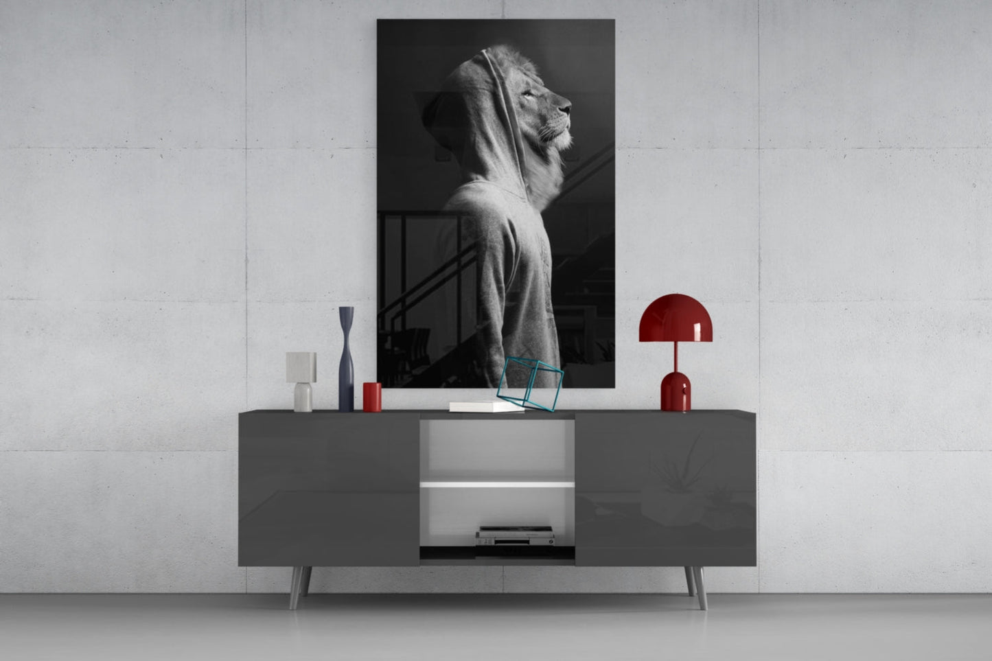 Black and white lion head glass wall art displayed above gray console table with red lamp and decorative objects.