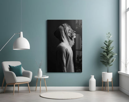 Black and white lion head profile glass wall art displayed on turquoise wall above modern chair and plants.