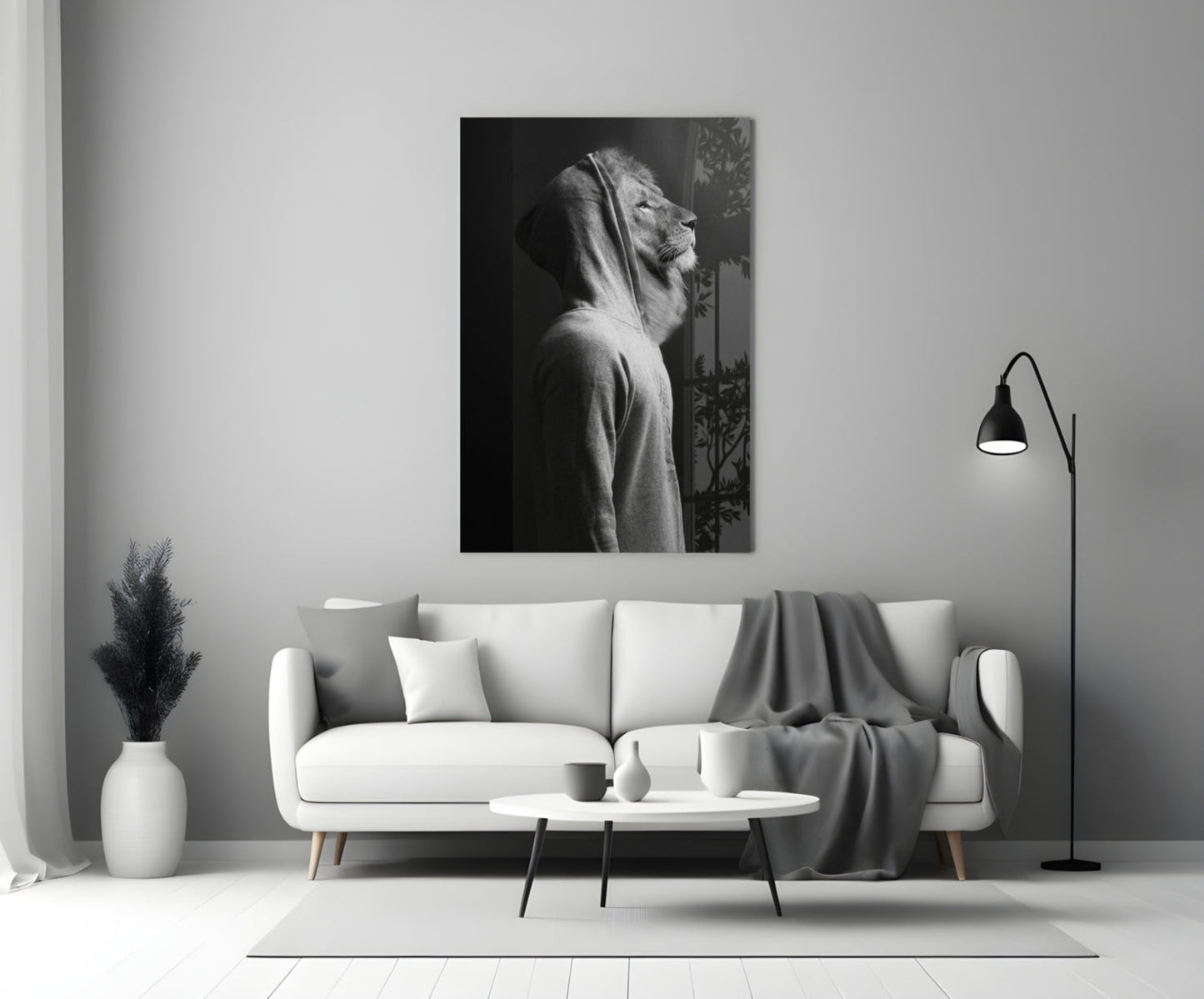 Black and white lion head profile glass wall art displayed above a white sofa in a minimalist living room interior.