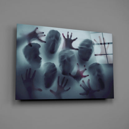 Frosted glass panel mounted on gray wall displaying blurred silhouettes of faces and hands in dark tones with horizontal lines.